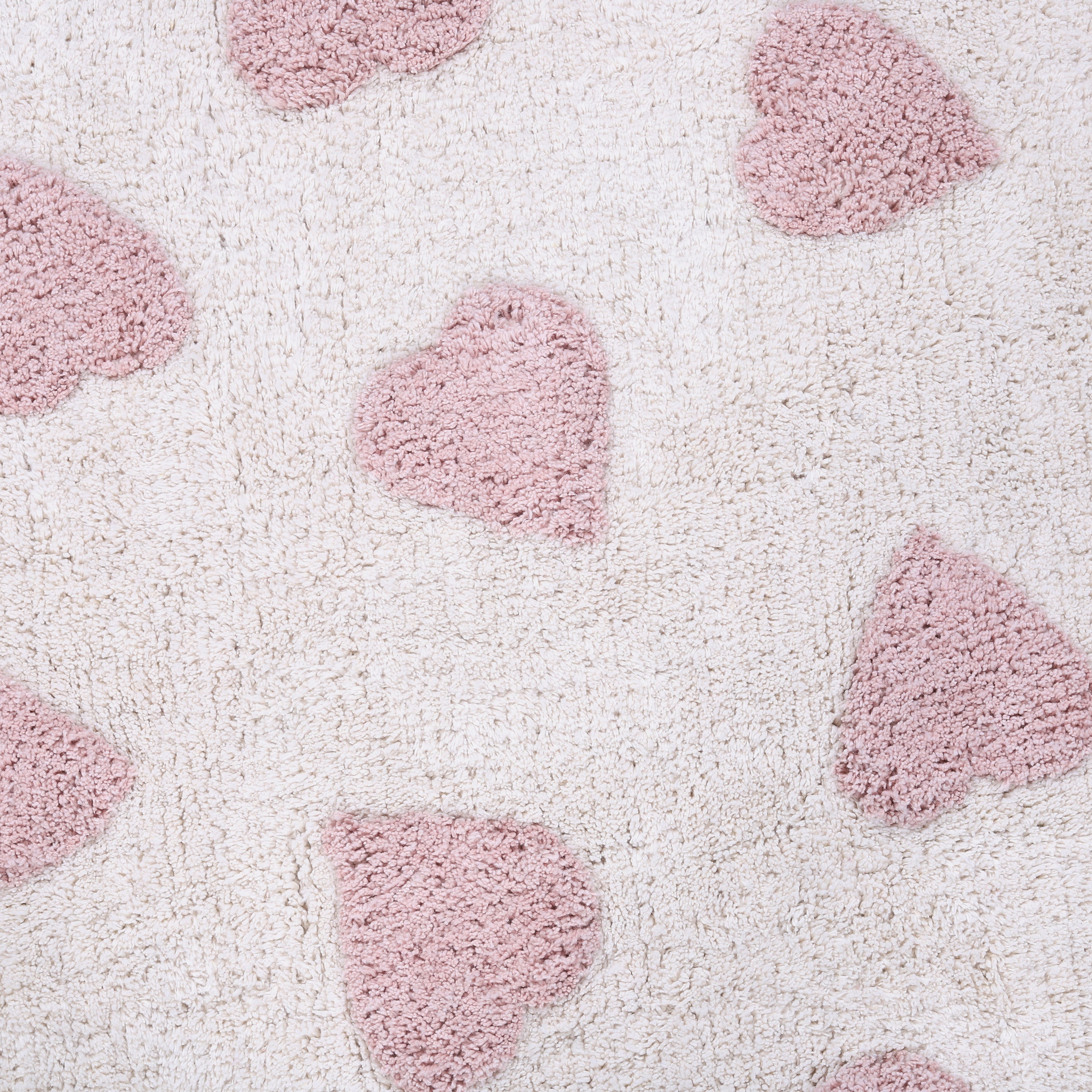 Kindervloerkleed in rechthoekige vorm met blush roze hartjes.
