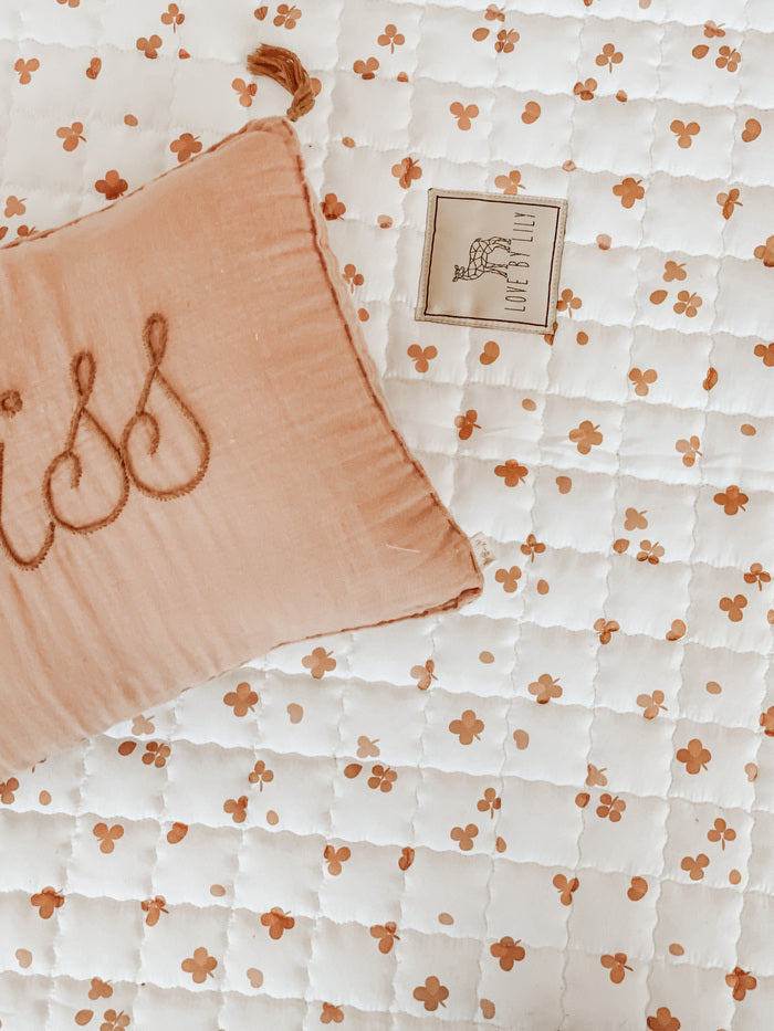 Zacht speelkleed met verspreide klavertjes – een knusse speelplek.